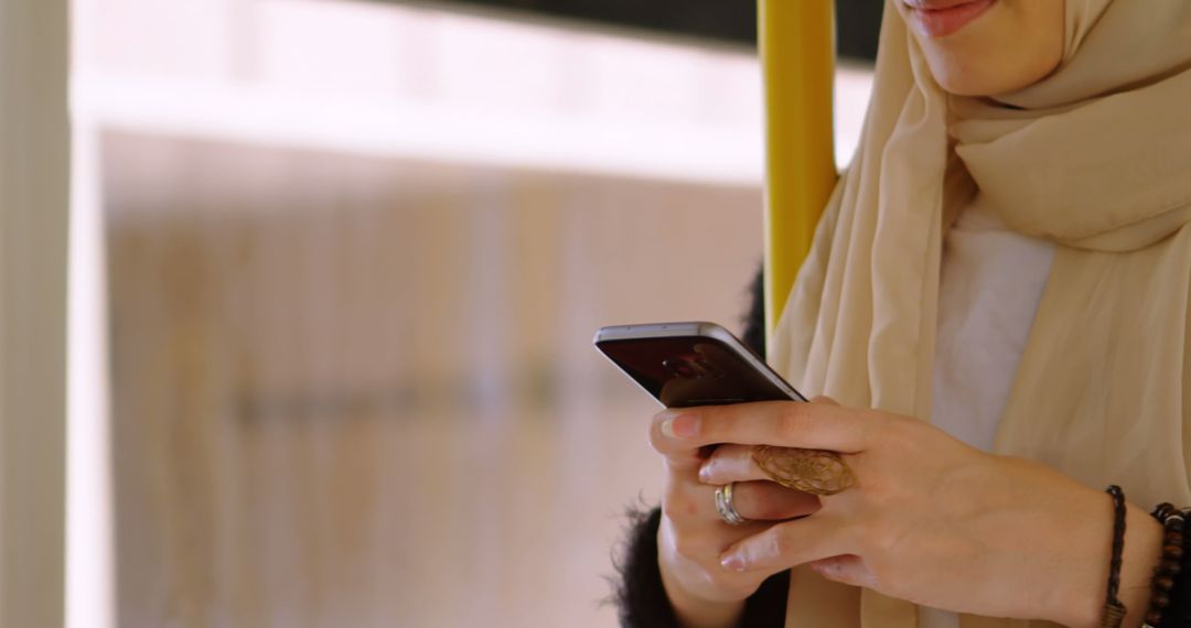 Asian Woman in Hijab Using Smartphone for Communication