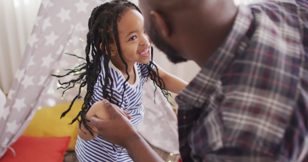 Joyful Father and Daughter Dancing Together at Home
