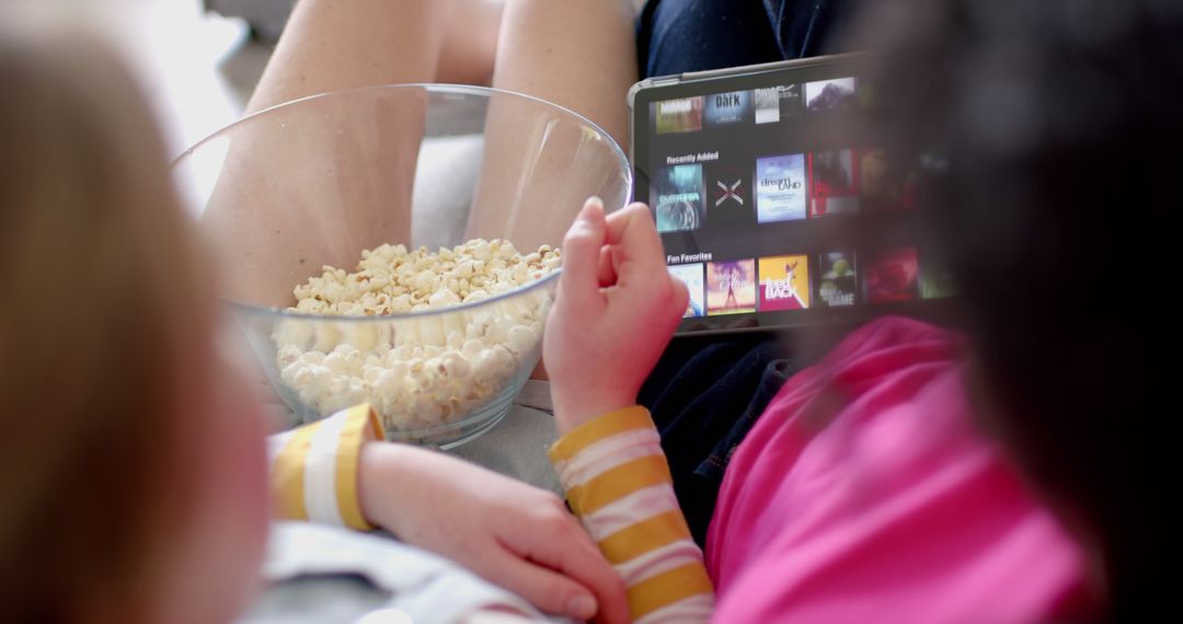 Children Watching Movie on Tablet with Popcorn - Free Images, Stock Photos and Pictures on Pikwizard.com