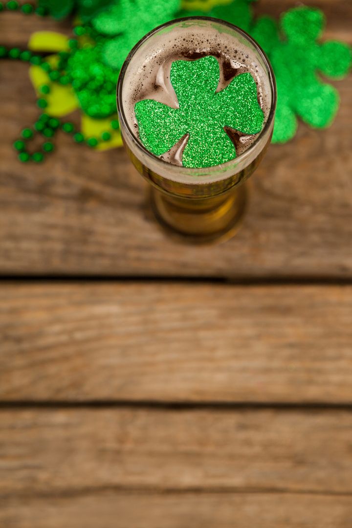 St. Patrick's Day Beer with Shamrock Decoration on Wooden Table - Free Images, Stock Photos and Pictures on Pikwizard.com