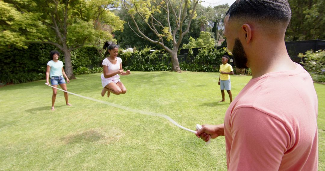 Multi-Generational Family Playing Backyard Rope Skipping