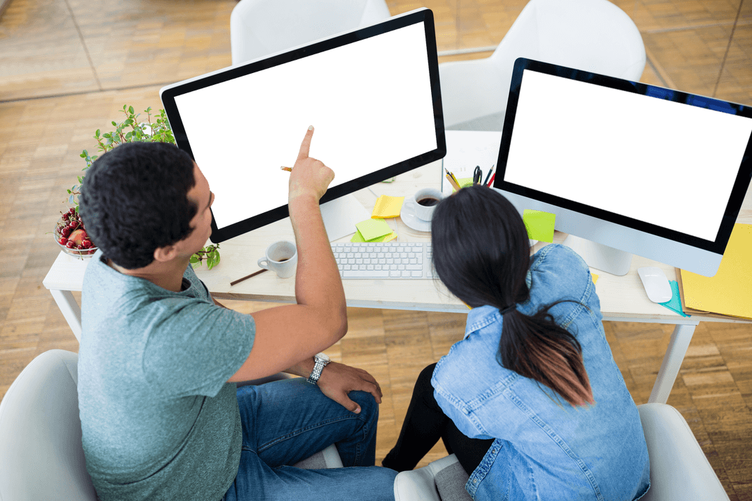 Two designers collaborating on transparent computer screens