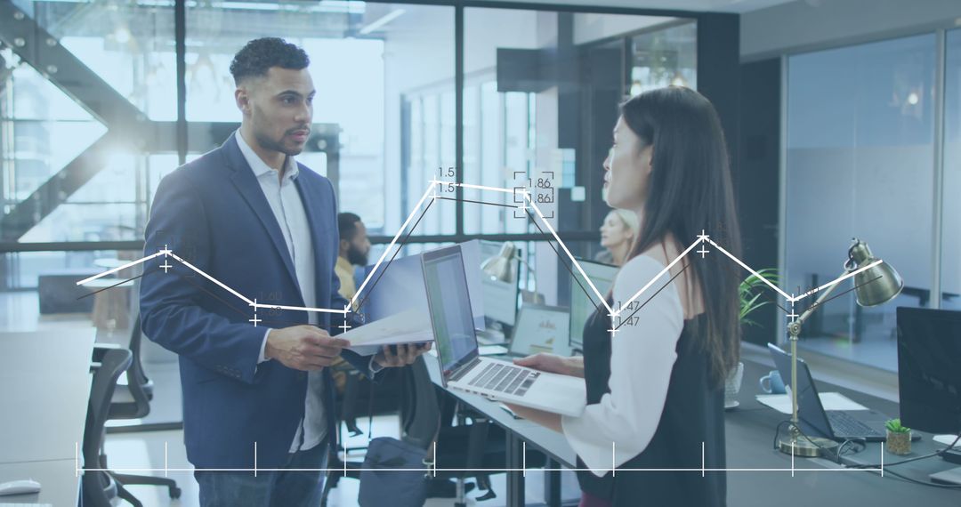 Diverse Coworkers Collaborating with Business Data in Modern Office