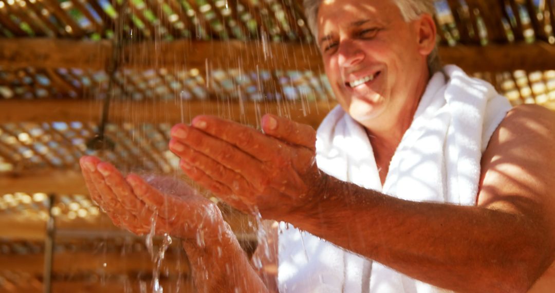 Old Man Enjoying Refreshing Outdoor Shower - Free Images, Stock Photos and Pictures on Pikwizard.com