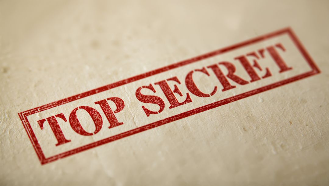 Diagonal red TOP SECRET stamp on beige textured paper showing distressed ink