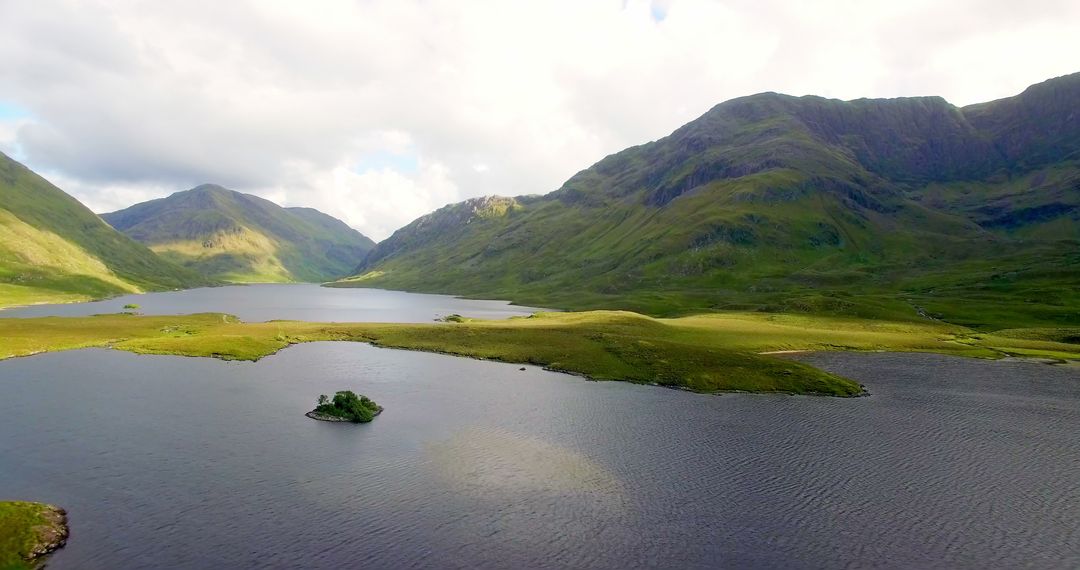 A serene landscape with a lake and green mountains exudes natural tranquility. - Free Images, Stock Photos and Pictures on Pikwizard.com