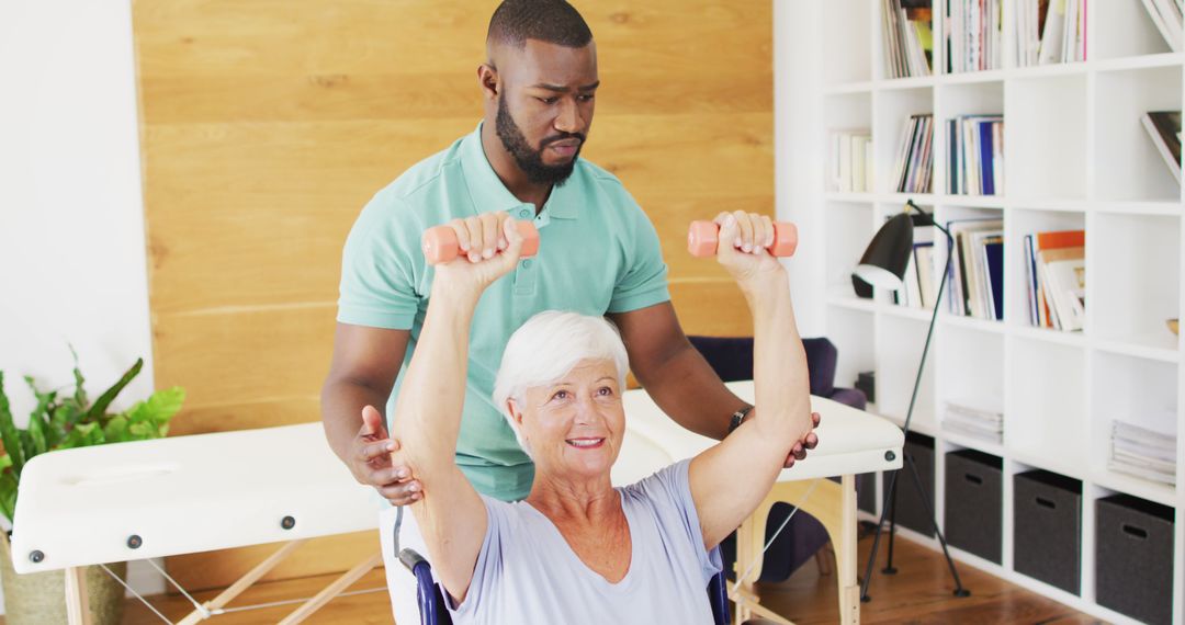 Image of happy african american male physiotherapist exercising with caucasian senior woman - Free Images, Stock Photos and Pictures on Pikwizard.com