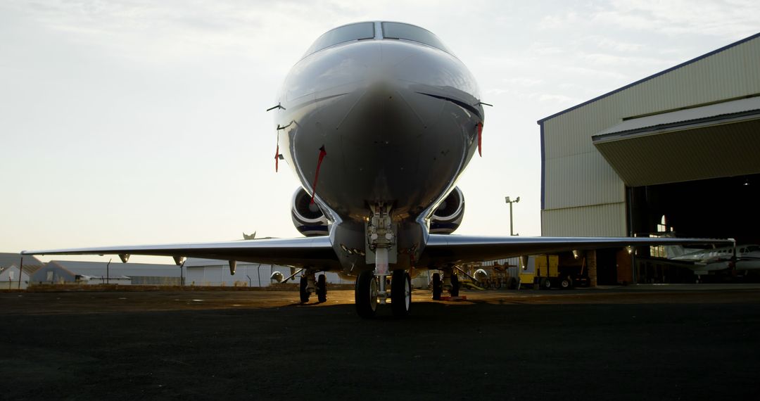 A private jet is parked on the tarmac at sunset, with copy space - Free Images, Stock Photos and Pictures on Pikwizard.com