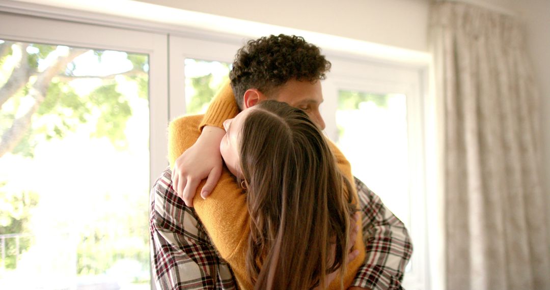 Happy Couple Embracing in Sunlit Home Interior