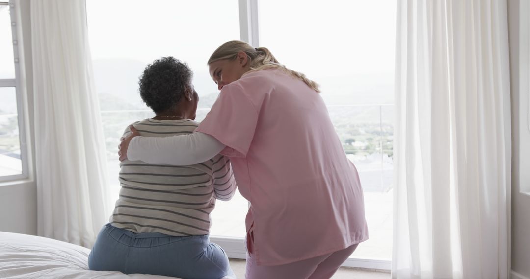 Nurse Comforting Senior Woman in Bright Room - Free Images, Stock Photos and Pictures on Pikwizard.com