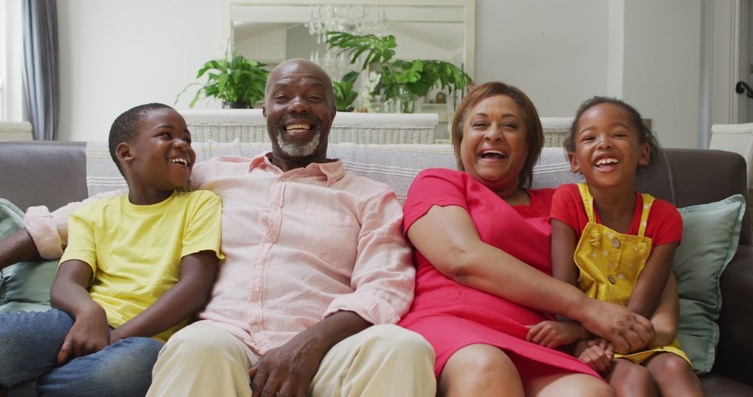 Smiling African American Family Enjoying Time Together on Couch - Free Images, Stock Photos and Pictures on Pikwizard.com