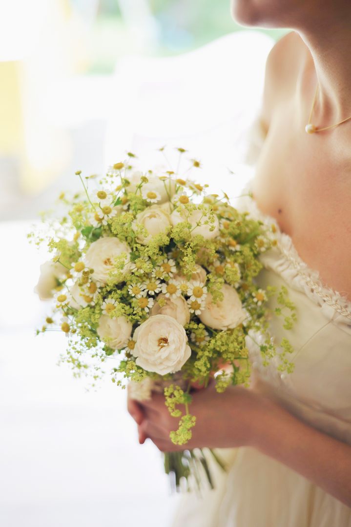 Bride Holding Bouquet of White Flowers and Greenery - Free Images, Stock Photos and Pictures on Pikwizard.com