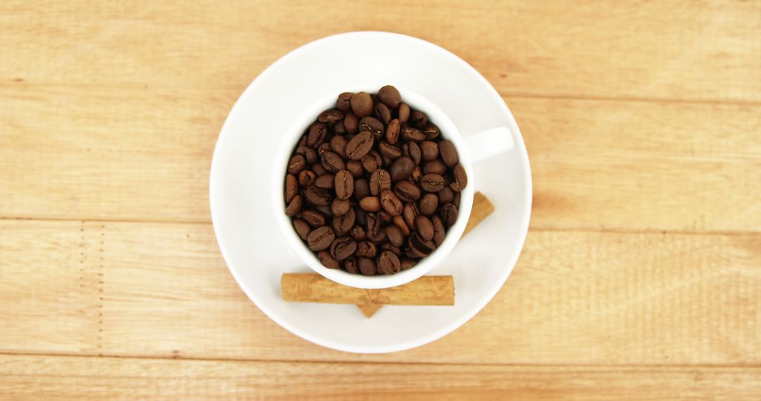 Top View of Coffee Beans in White Cup with Biscotti on Wooden Table - Free Images, Stock Photos and Pictures on Pikwizard.com