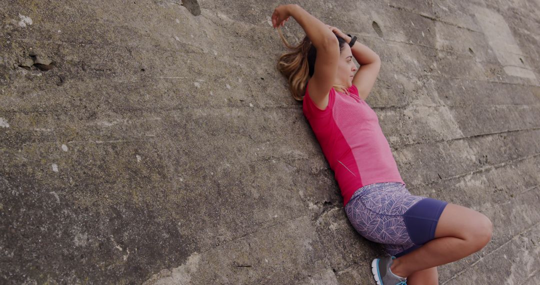 Fit Woman Stretching Against Stone Wall in Sportswear Outdoors - Free Images, Stock Photos and Pictures on Pikwizard.com