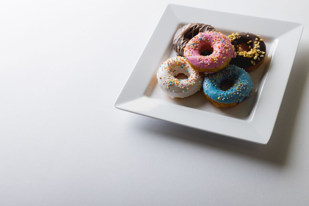 Assorted Colorful Donuts on White Plate - Free Images, Stock Photos and Pictures on Pikwizard.com