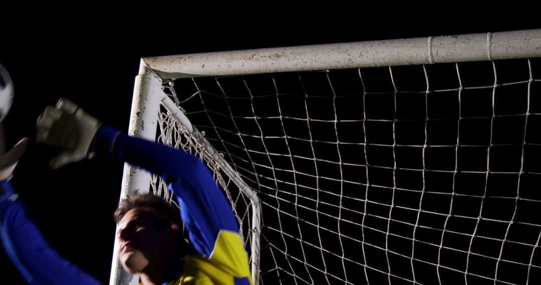 Goalkeeper Attempting to Make a Save During Night Soccer Match - Free Images, Stock Photos and Pictures on Pikwizard.com