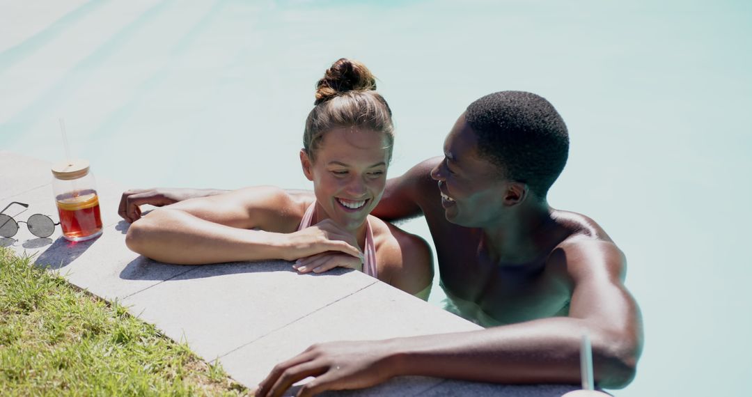 Couple Joyfully Relaxing in Swimming Pool on Sunny Day