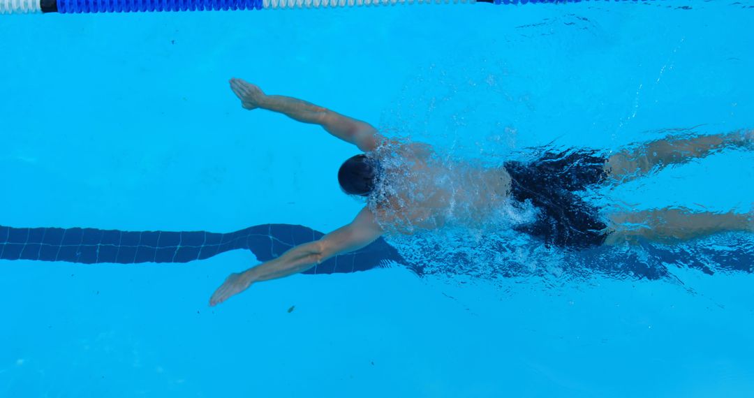 Male Swimmer Doing Butterfly Stroke in Clear Blue Pool - Free Images, Stock Photos and Pictures on Pikwizard.com