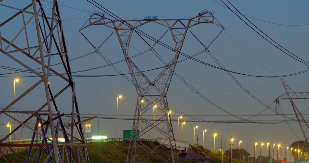 High Voltage Power Lines at Dusk With City Lights in Background - Free Images, Stock Photos and Pictures on Pikwizard.com