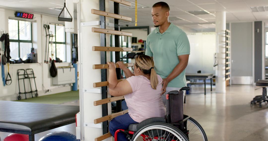 Physiotherapist Assisting Woman in Wheelchair During Rehabilitation Exercise in Therapy Center - Free Images, Stock Photos and Pictures on Pikwizard.com