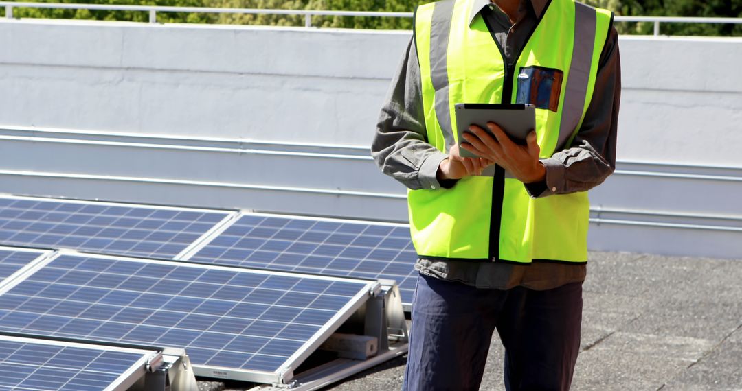 Engineer Inspecting Solar Panels on Rooftop - Free Images, Stock Photos and Pictures on Pikwizard.com