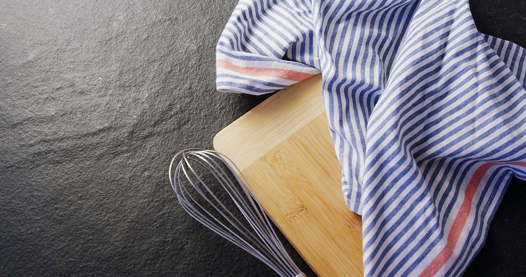 Striped Kitchen Towel and Whisk on Wooden Cutting Board - Free Images, Stock Photos and Pictures on Pikwizard.com