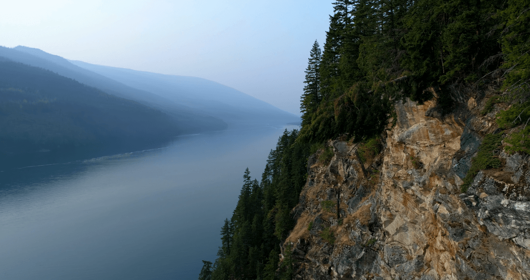 Majestic Mountain View with Fog and River under Transparent Morning Sky