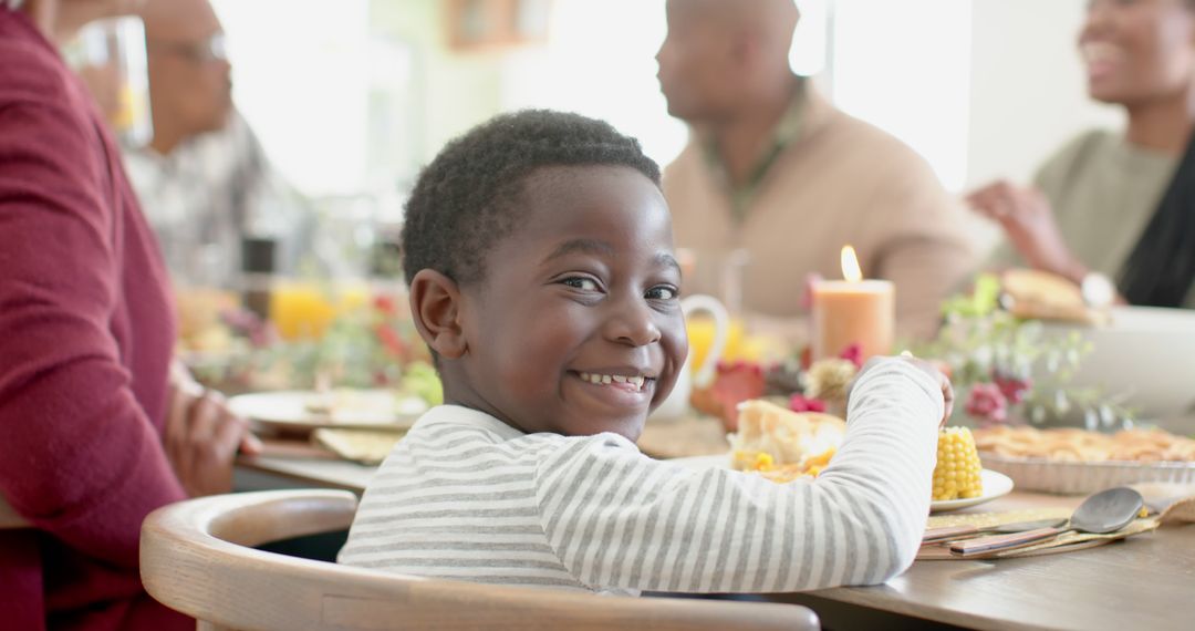 Smiling African American Child Enjoying Family Dinner Gathering - Free Images, Stock Photos and Pictures on Pikwizard.com