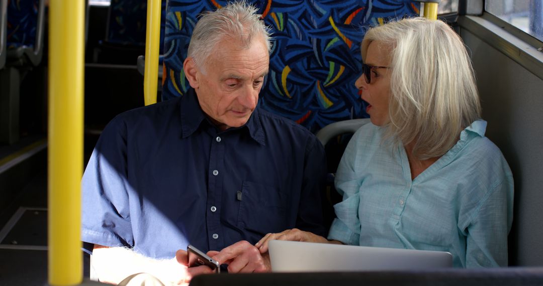 Senior Couple Navigating Technology on City Bus