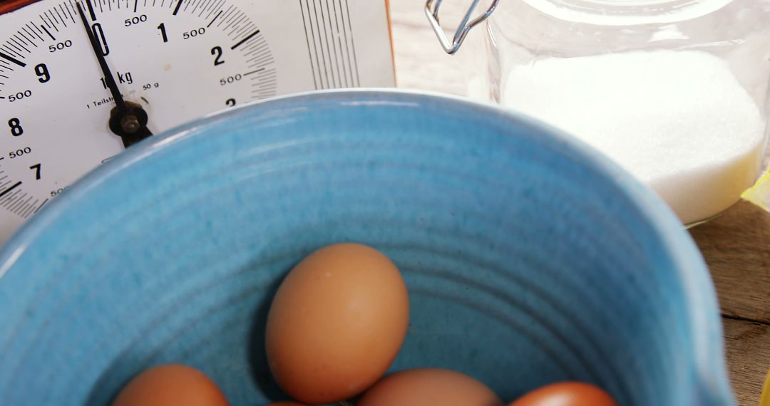 Fresh Brown Eggs in Blue Bowl with Kitchen Scale and Sugar Jar - Free Images, Stock Photos and Pictures on Pikwizard.com