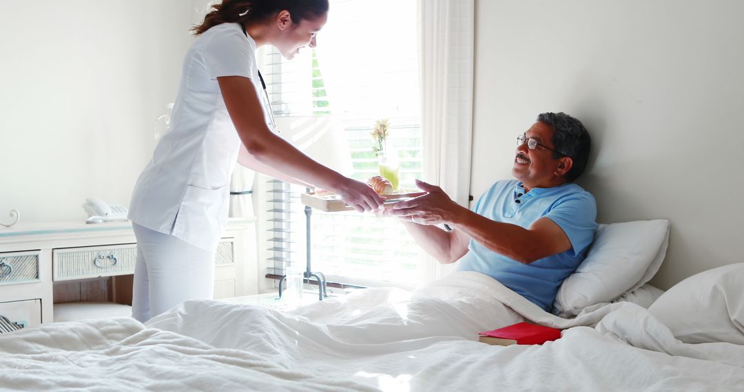 Nurse Providing Care to Elderly Man in Bed at Home - Free Images, Stock Photos and Pictures on Pikwizard.com