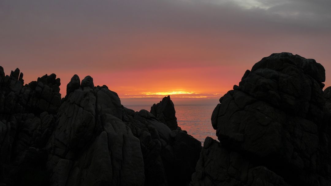 Dramatic Sunset Over Rocky Ocean View - Free Images, Stock Photos and Pictures on Pikwizard.com