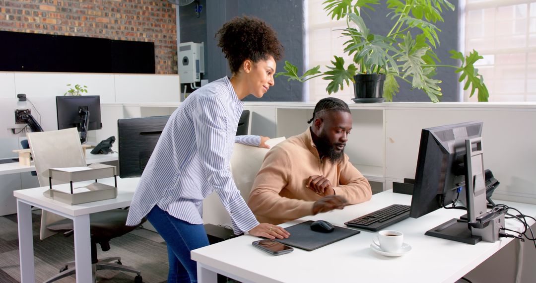 Colleagues Collaborating on Project at Modern Office Workspace