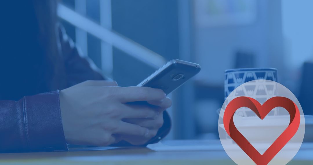 Person Using Smartphone at Table in Contemporary Setting