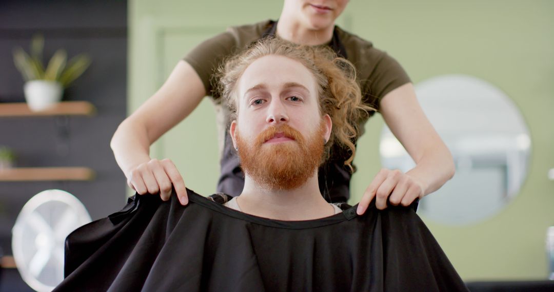 Barber Preparing Confident Bearded Redhead Man for Haircut - Free Images, Stock Photos and Pictures on Pikwizard.com