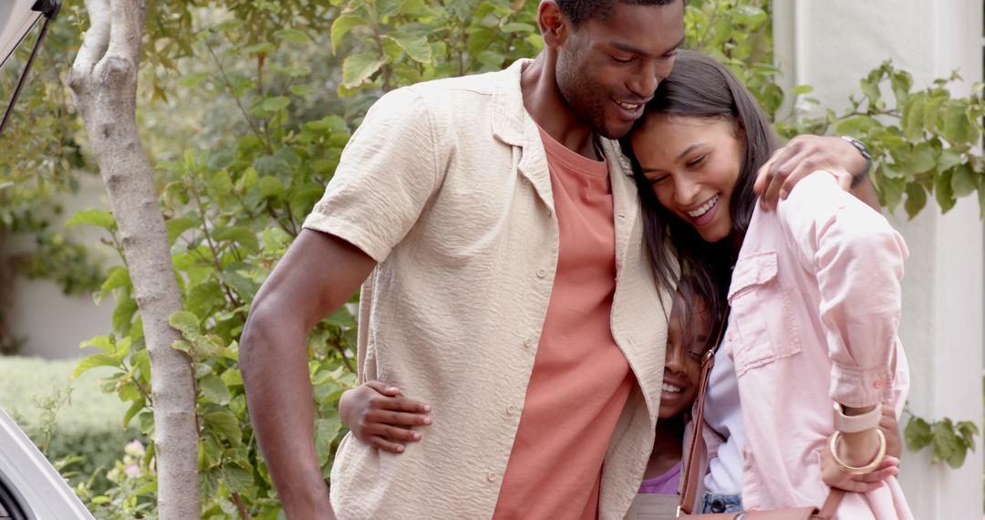 Joyful Family Embracing Together Outdoor with Open Car
