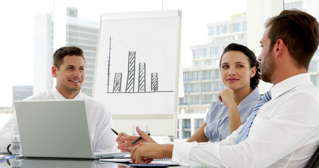 Business Team Meeting with Presentation and Laptops in Modern Office