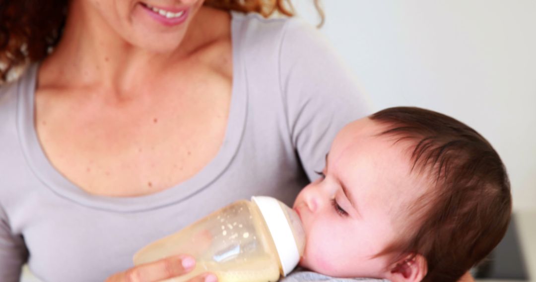 Smiling Mother Feeding Baby with Bottle - Free Images, Stock Photos and Pictures on Pikwizard.com