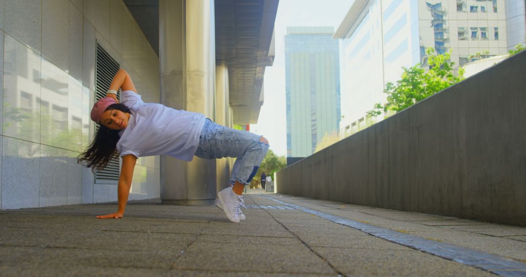 Woman Performing Street Dance Move on Sidewalk in Urban Area - Free Images, Stock Photos and Pictures on Pikwizard.com