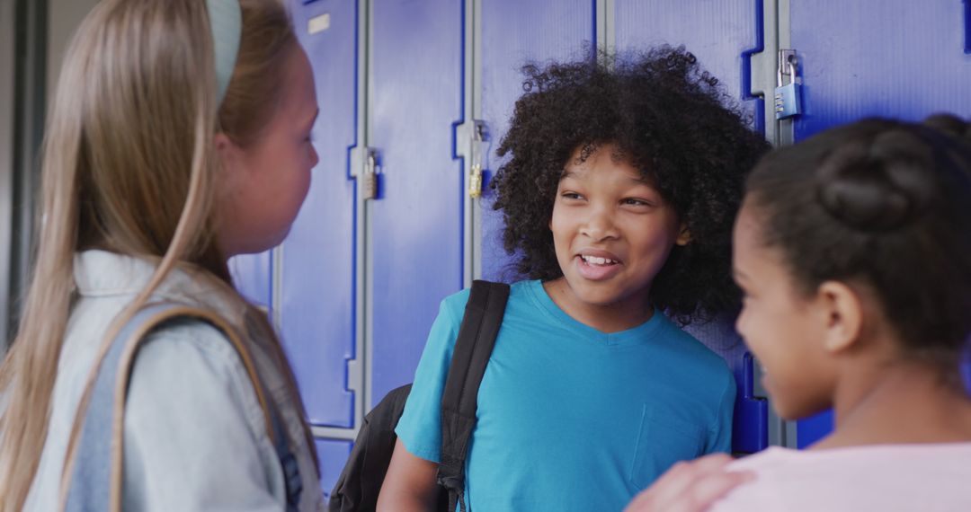 Diverse Schoolgirls Conversing in Corridor