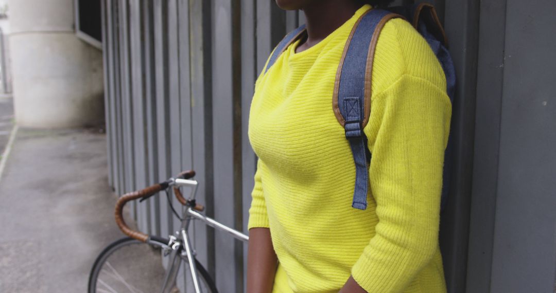 Young Woman Wearing Yellow Sweater Relaxing with Bicycle Outdoors - Free Images, Stock Photos and Pictures on Pikwizard.com