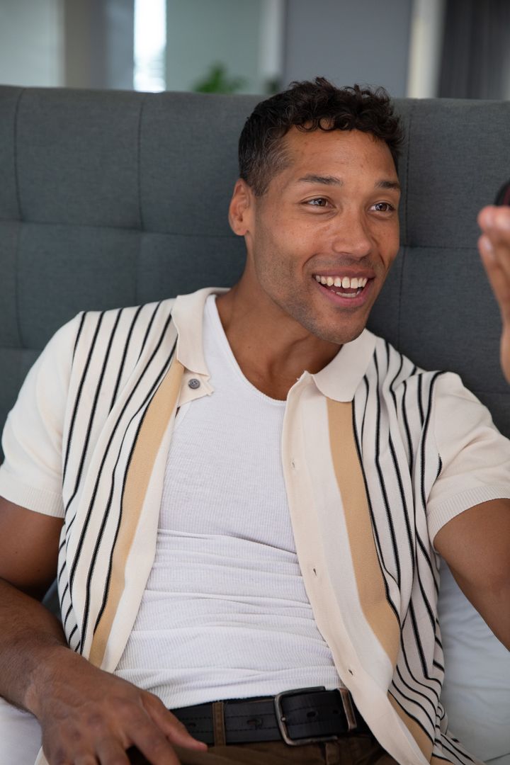 Smiling Man Taking Selfie While Seated at Home by Window