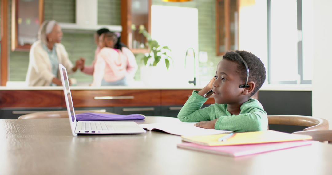 African American child uses laptop for online learning with family - Free Images, Stock Photos and Pictures on Pikwizard.com