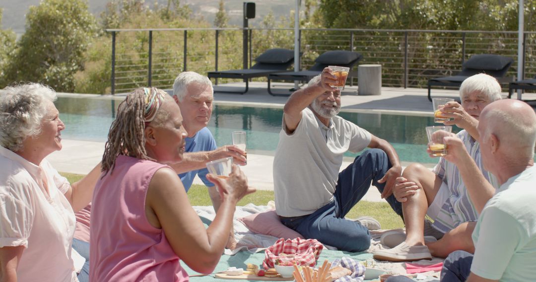 Elderly Friends Enjoying Poolside Picnic and Toasting - Free Images, Stock Photos and Pictures on Pikwizard.com