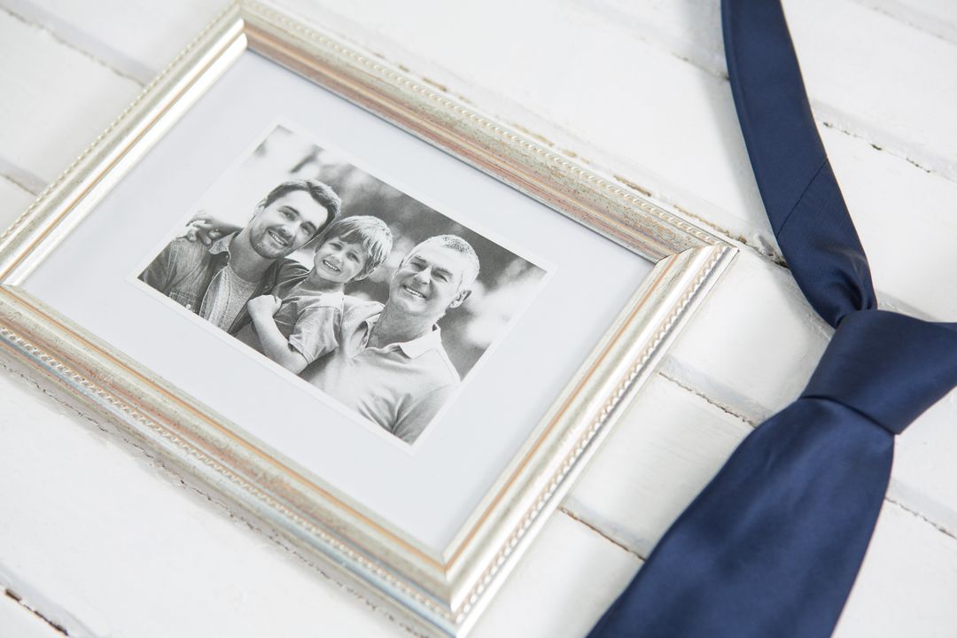 Family Photo Frame with Necktie on Wooden Table - Free Images, Stock Photos and Pictures on Pikwizard.com