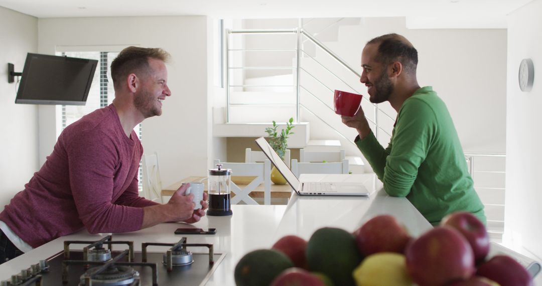 Happy Man Enjoying Coffee Chat in Modern Kitchen - Free Images, Stock Photos and Pictures on Pikwizard.com