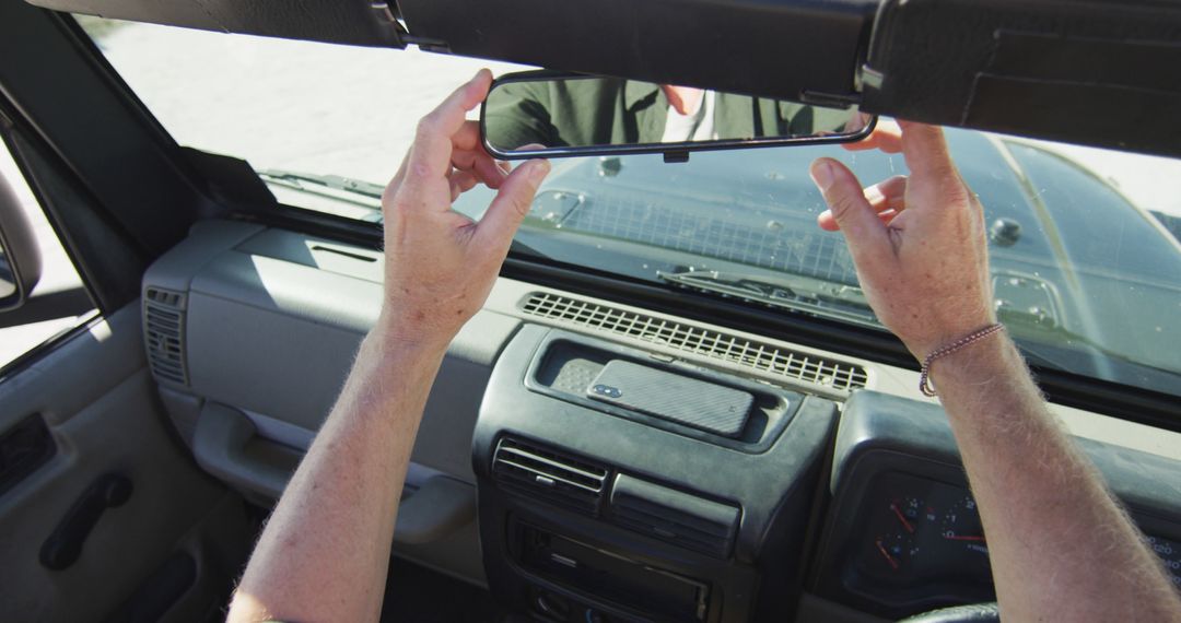 Person Adjusting Rear View Mirror in Car - Free Images, Stock Photos and Pictures on Pikwizard.com