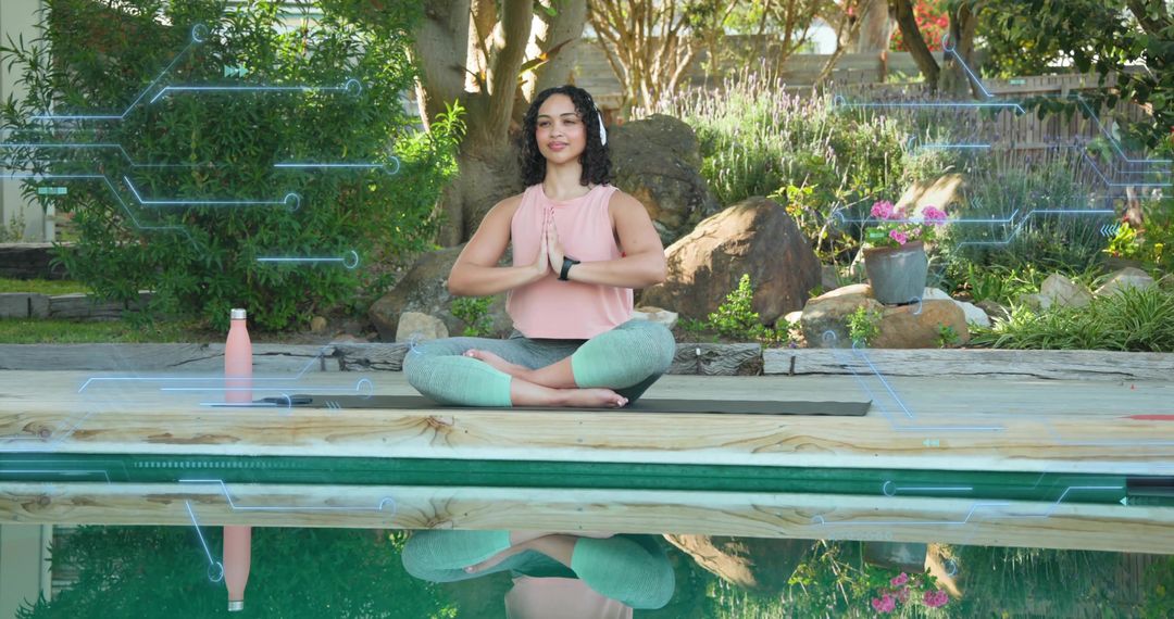 Practicing mindful yoga by pool with wearable tech, meditation reflection in backyard garden