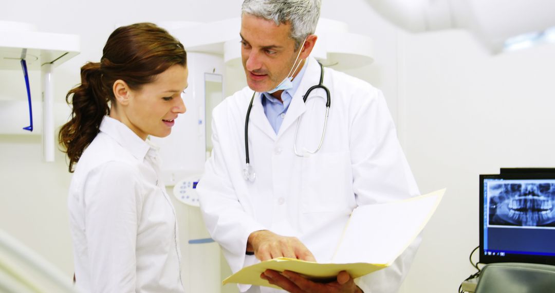 Doctor Discussing Report with Female Patient in Medical Office - Free Images, Stock Photos and Pictures on Pikwizard.com