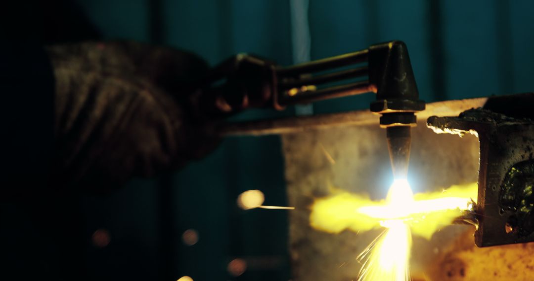 Welder using cutting torch with bright flame and sparks - Free Images, Stock Photos and Pictures on Pikwizard.com